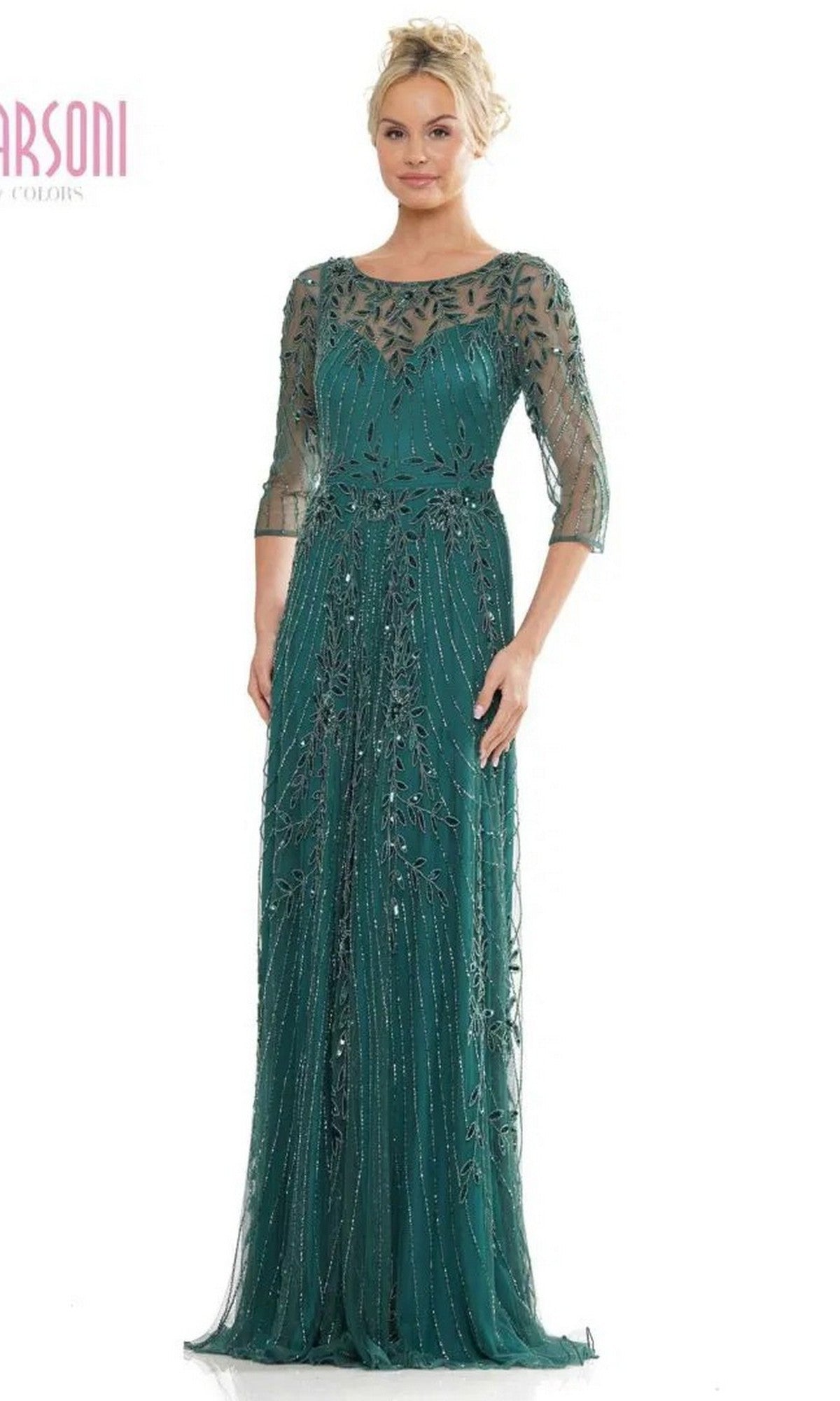 A woman wears the Marsoni MV1283 Long Formal Dress in deep green, featuring sheer sleeves and intricate beaded details—a sophisticated option for the mother of the bride or any formal event.